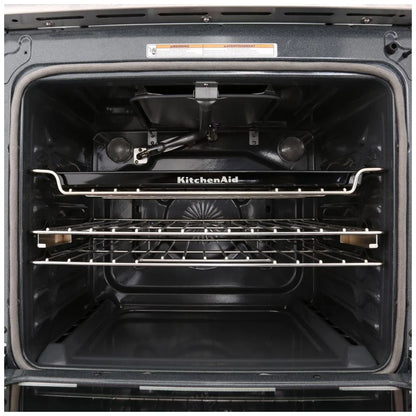 Close-up view of the KitchenAid KSGG700EBS gas slide-in range interior, showcasing the spacious oven with multiple racks and AquaLift® steam clean system