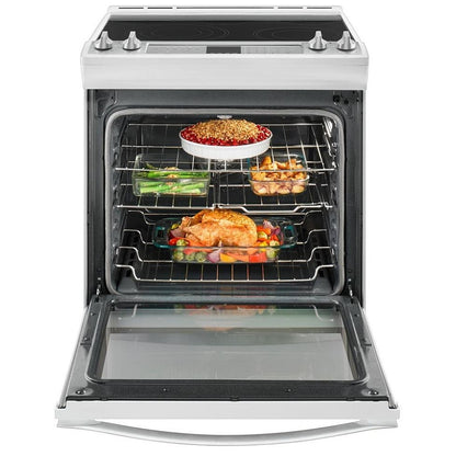 Whirlpool 30-inch slide-in electric range with food cooking in the oven, highlighting the even heat distribution and convection system for consistent results.